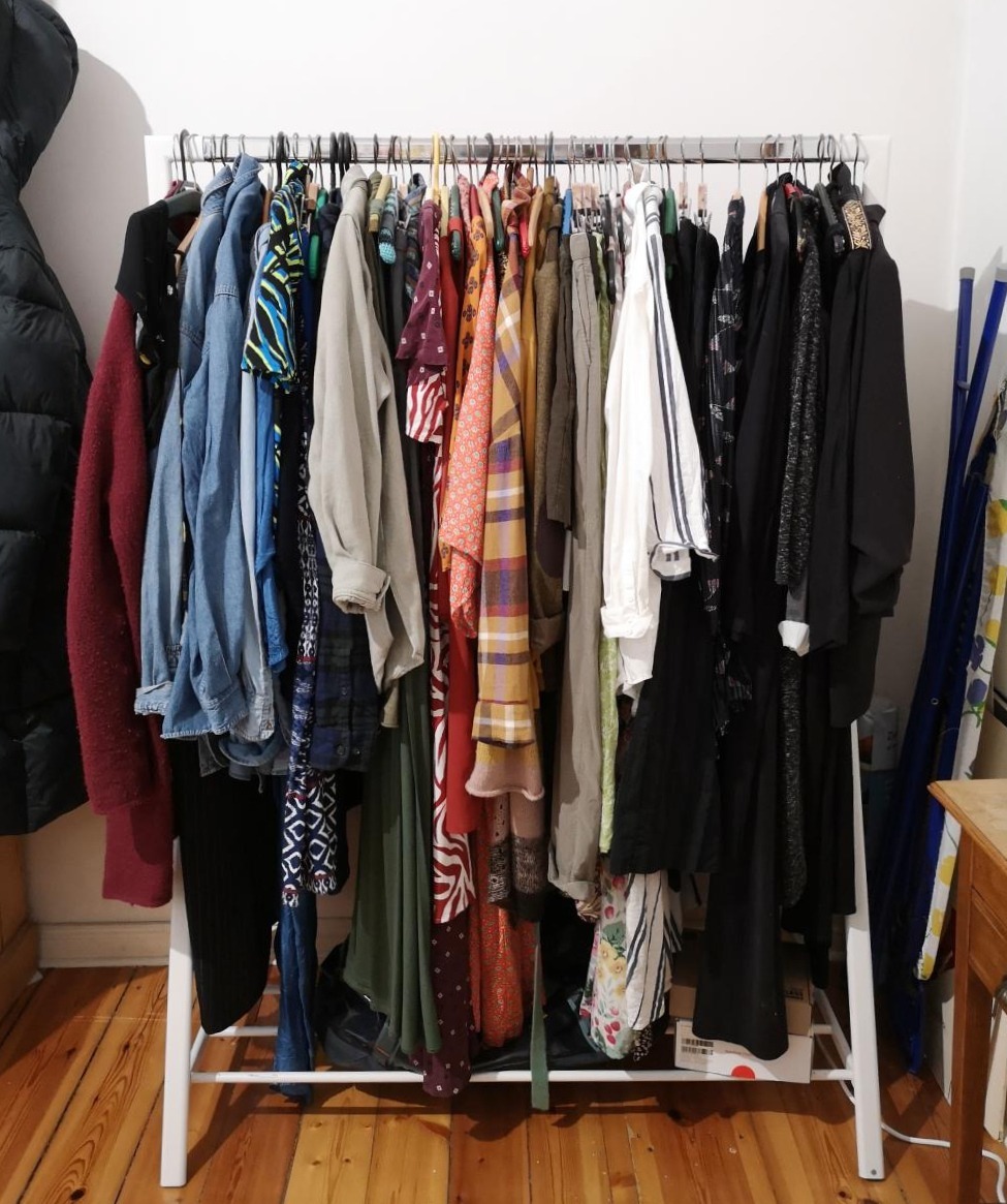 A white, messy clothes rail in Berlin.